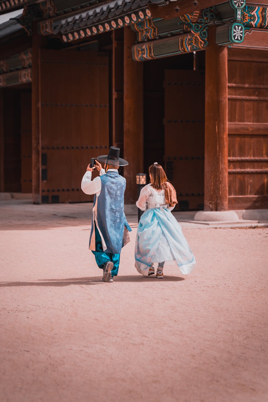 couple in traditional costumes on courtyard of a temple